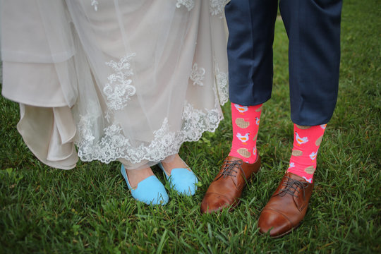 Wedding Photography Bride and Grooms Feet – Blue Wedding Shoes and Brown Men’s Leather Shoes with Silly Neon Pink Chicken and Waffles Socks