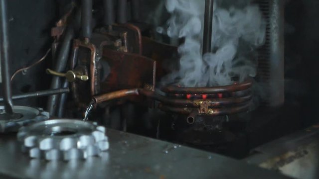 Hardening and heat treatment of metal parts for mechanical engineering, close-up, heat treatment of metal parts and products on a call, close-up, industry, fire