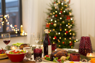 christmas dinner and eating concept - food and drinks on table at home