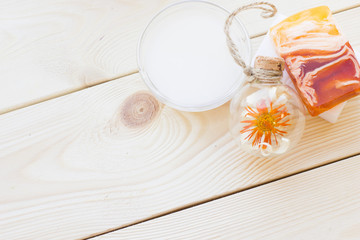 Spa and wellness setting with oil and yellow flower