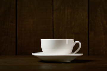 one classic coffee or tea cup on a dark wooden background