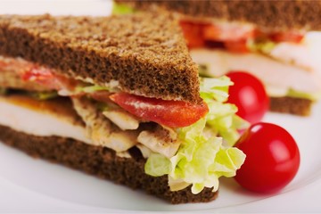 Sandwich with ham and vegetables on wooden