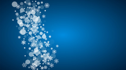 Christmas frame with falling snow on blue background. Horizontal Merry Christmas frame with white frosty snowflakes for banners, gift cards, party invitations and special business offers.