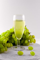 white wine and grape on a marble background