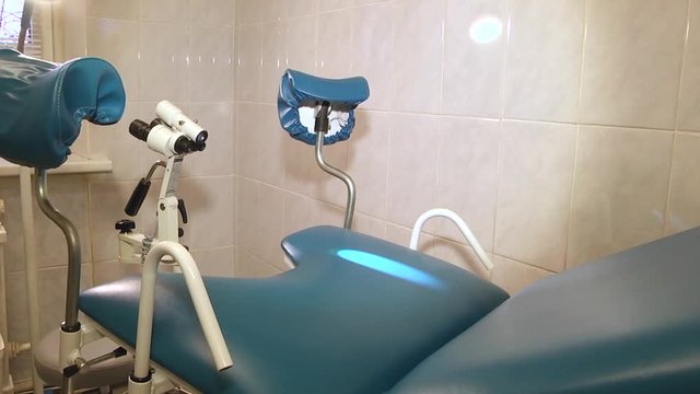 The image of blue gynecological chair.  Gynecology in the clinic.  Gynecology room, medical instruments, interior of the genicology clinic. 