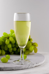 white wine and grape on a marble background