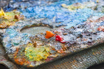 Artistic palette with oils paints. Paint for painting on canvas.