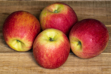 Closeup of ripe juicy big red apples on a wooden table. healthy eating. vitamins on the table 