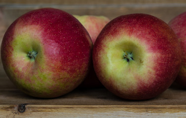 Closeup of ripe juicy big red apples on a wooden table. healthy eating. vitamins on the table 