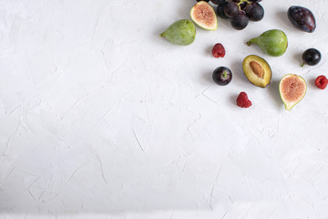 Flat kay italian wine appetizer Fig Grape Plum Raspberry White background Copy space