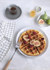 Belgian waffles Slow food breakfast concept figs raspberries honey Espresso coffee white wooden background Flat lay Copy space