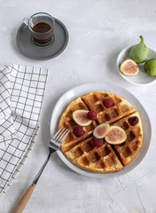 Belgian waffles Slow food breakfast concept figs raspberries Espresso coffee white wooden background Flat lay Copy space
