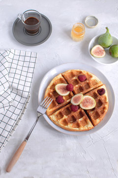 Belgian waffles Slow food breakfast concept figs raspberries honey Espresso coffee white wooden background Flat lay Copy space Toned image