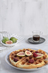 Selective focus Belgian waffles Slow food breakfast concept figs raspberries honey Espresso coffee white wooden background Horizontal Perspective