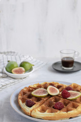 Selective focus Belgian waffles Slow food breakfast concept figs raspberries honey Espresso coffee white wooden background Horizontal Persperctive