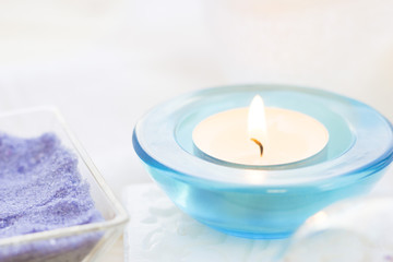 Spa and wellness setting with oil and yellow flower