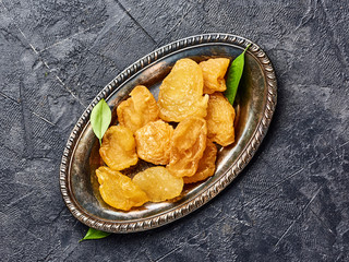 Dried pear, apricot or peach on black background. Top view of candied fruits.