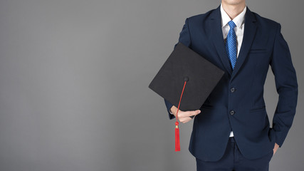 business man is holding graduation hat, business education concept
