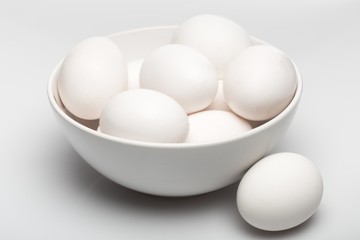 White Eggs in a Bowl on Grey Background