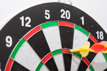Close up shot red&yellow dart arrow on dartboard, Dart board isolated on a white background, Throw...
