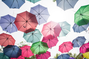 Beautiful display of colorful hanging umbrellas in a outdoor, Colorful hanging umbrellas on white sky background in Sunny day