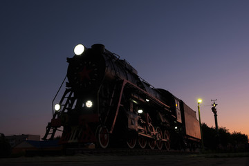 monument to the locomotive against the night sky on a summer day
