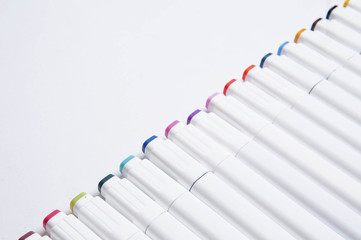 Top view of colorful markers on white background. Place for text