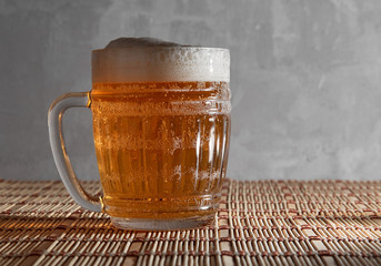 Beer mug with beer on gray background