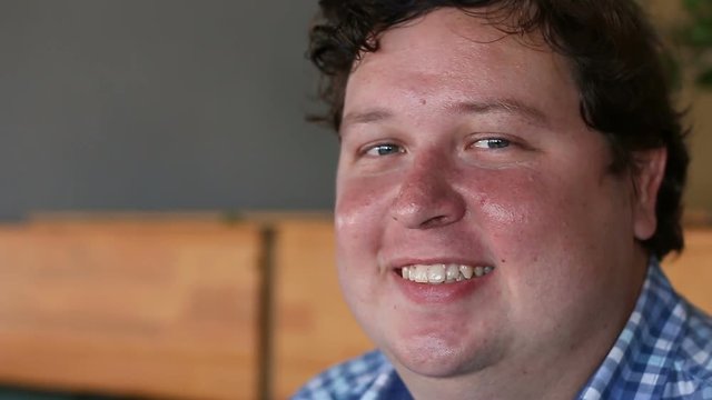 Young man face, a high detailed portrait, looking at camera and winking