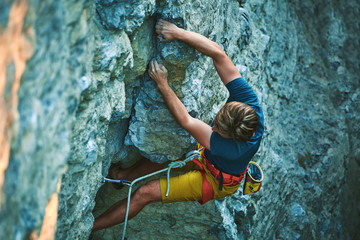 rock climbing. man rock climber climbing the challenging route on the rocky wall