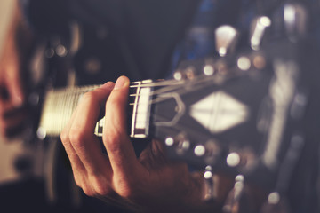 Closeup hands playing an electric guitar