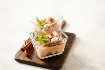 Cashew vegan cake with apple mousse and cinnamon in portion bowls decorated with mint overhead