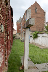 concrete cross near the wall