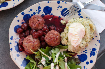 le boulet  with cherry sauce, herbs and mash, view from above