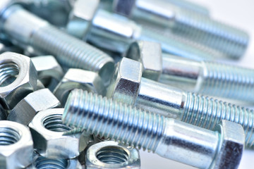 Fasteners on a white background. Manufacture of metal products.