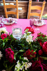Decorated area in gold and burgundy colors with white candles and flowers