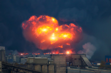 Powerful explosion with bright flashes and black smoke in the city.