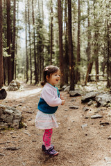 Little Girl Smiling while Hiking on Nature Path