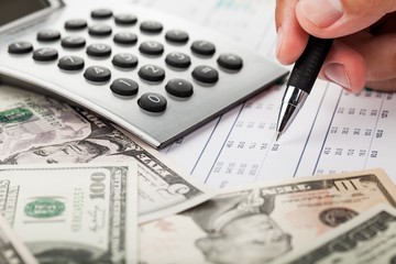 Fototapeta premium Close-up of a Businessman Analyzing Financial Figures with