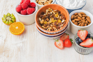 Healthy eating, paleo gluten free nut and fruit granola served with fruits and berries, nut milk, copy space, selective focus
