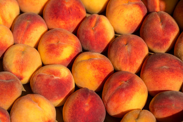 Fototapeta na wymiar beautiful big red peaches in a drawer