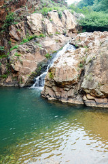 Fototapeta na wymiar Waterfall into clear dam
