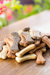 Dog tasty colored biscuits on wooden background 