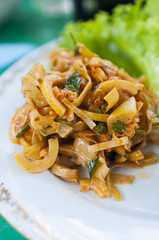 Spicy chopped bamboo salad on a white dish close-up