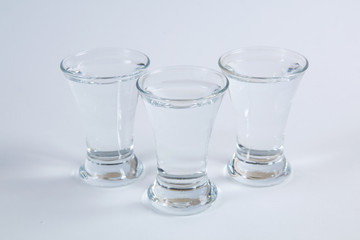 vodka in shot glasses on a white background