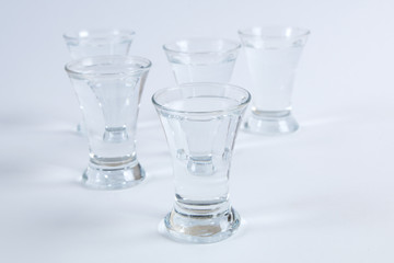vodka in shot glasses on a white background