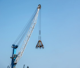 Big construction crane on blue sky background copy space