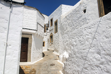 Fototapeta na wymiar A view of streets and ancient houses in the island of Patmos, Greece in summer time