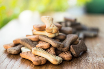 Dog tasty colored biscuits on wooden background 