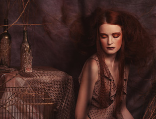 Fashion portrait of romantic beautiful girl with hairstyle, red lips, art dress.Princess in mistery...